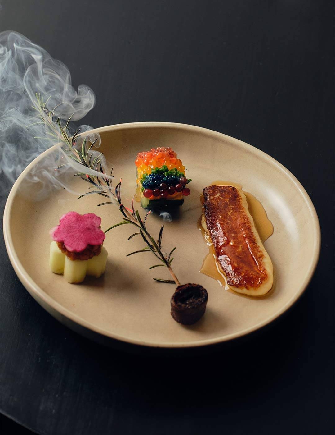 Beautifully presented fine dining entree at Emerald City restaurant in Healesville, with honey whisky halloumi, rainbow caviar, and smoked rosemary skewer.